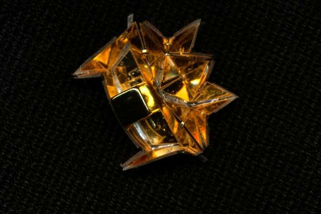 Centimeter-long origami robot climbs inclines, swims, and carries loads